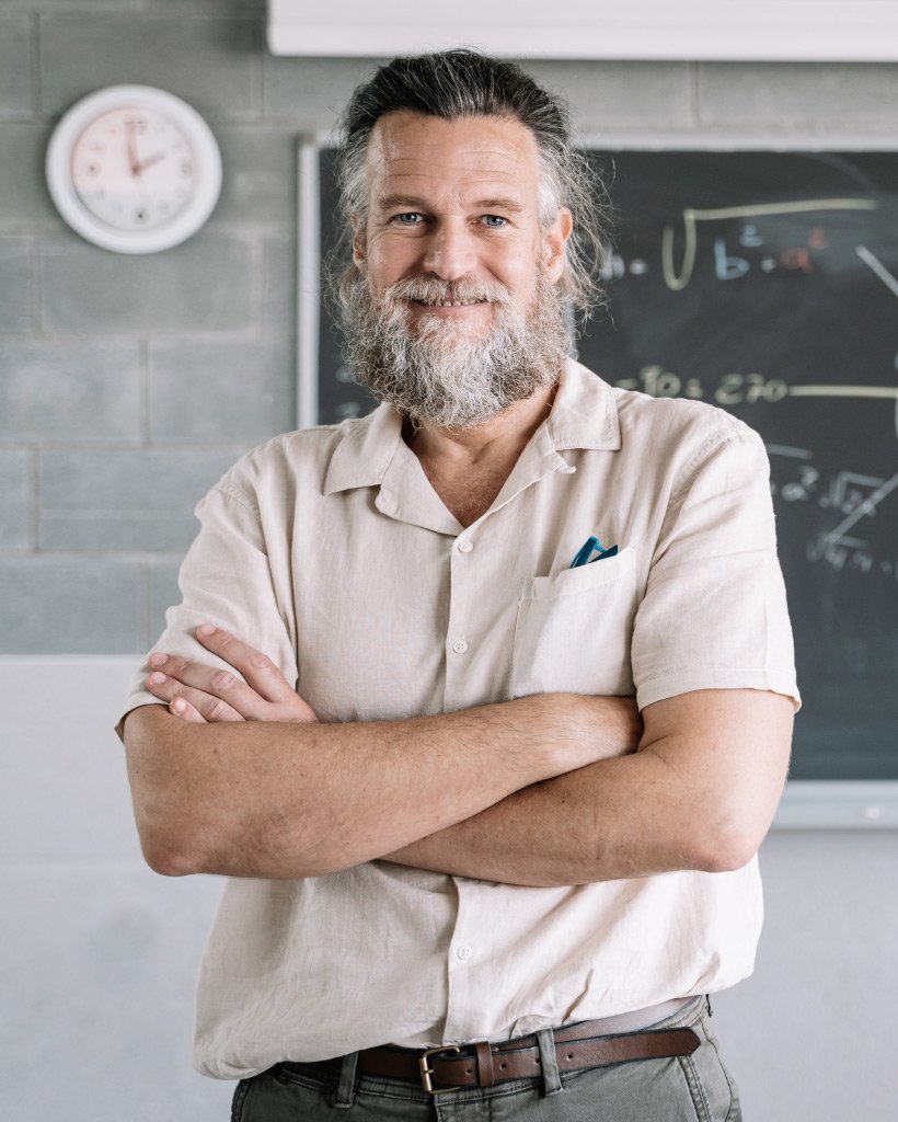 smiling friendly bearded middle aged male teacher UP8H2NK