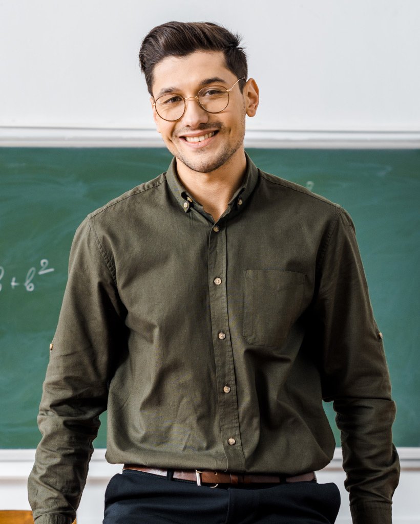 smiling male teacher in formal wear looking at cam 2NLG2E9